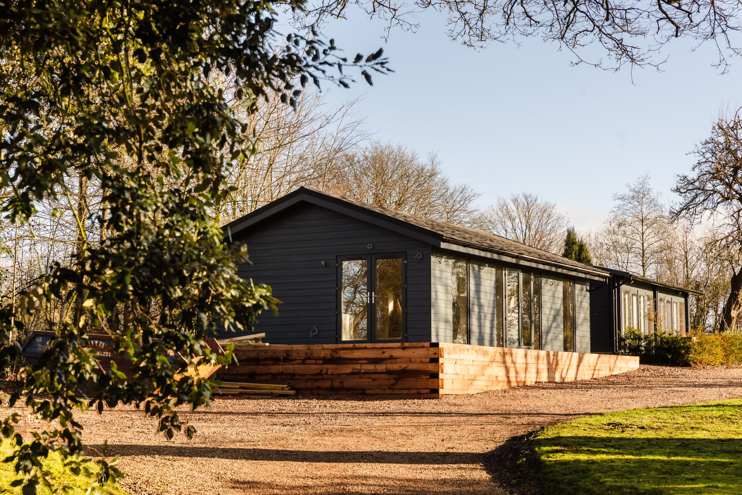 A cabin from an angle behind trees