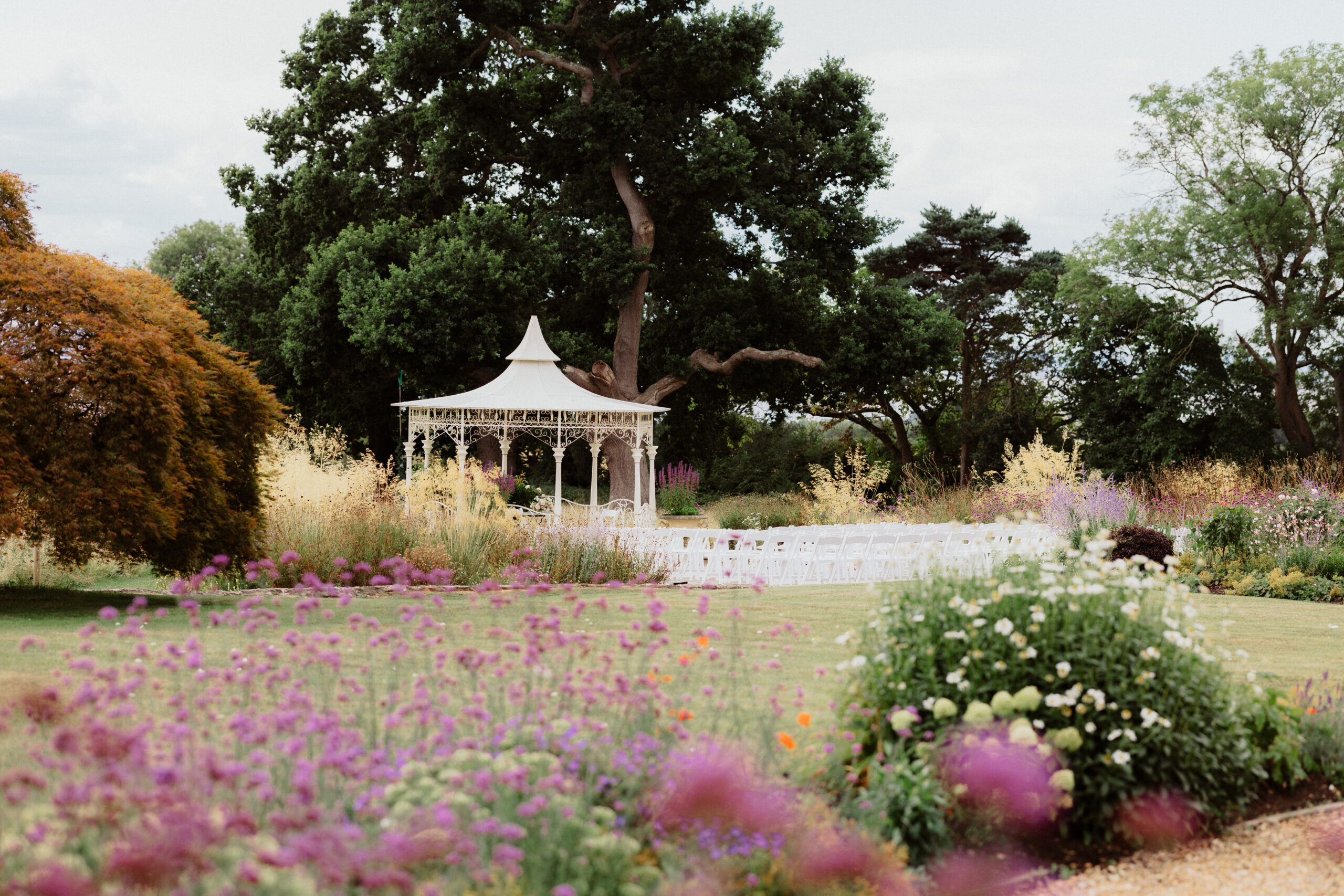 bridge and groom kissing with family and friends around holding sparklers